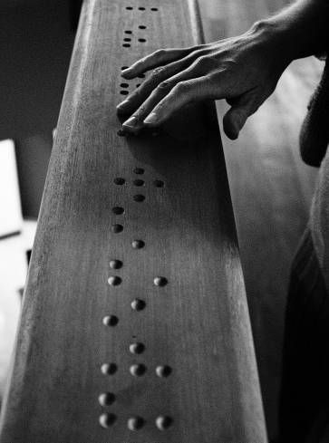 Wood-carved braille code of the word 'premier' (French for 