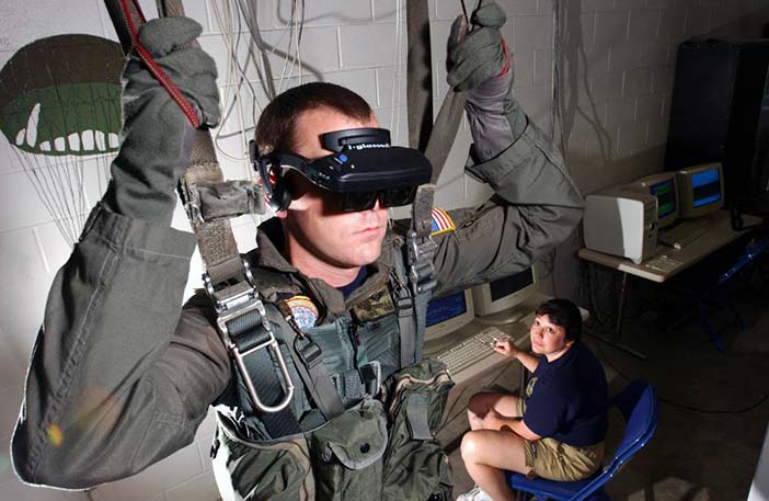 Virtual Reality (VR) parachute trainer. Students wear the VR glasses while suspended in a parachute harness, and then learn to control their movements through a series of computer-simulated scenarios.